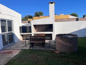 a table and bench in front of a building at La martinez in San Antonio de Areco
