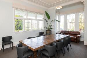 a dining room with a large wooden table and chairs at Cedar House in Gisborne +81 photos
