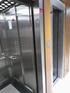 a walk in shower with stainless steel doors in a room at Loft Centro Cívico in San Juan