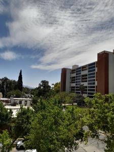 a view of a building with trees in the foreground at Loft Centro Cívico in San Juan