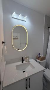 a bathroom with a sink and a mirror at Private Creekstone Basement Suite with Kitchen in Calgary