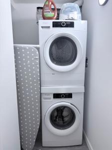 two washing machines and a washer and dryer at Private Creekstone Basement Suite with Kitchen in Calgary