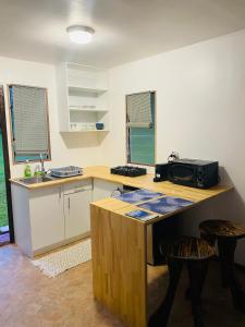a kitchen with a counter with a microwave on it at Huahine Serenity Cottage in Maroe