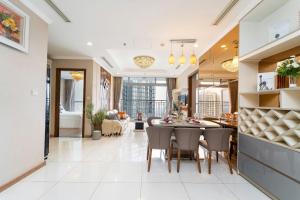 a dining room and living room with a table and chairs at Elysian Suites In Landmark Saigon by VNS in Ho Chi Minh City