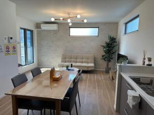 a living room with a table and a couch at yuanquanHOTEL in Osaka