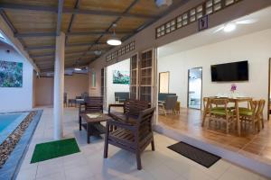a rendering of a living room and dining room at The Hidden Lagoon in Rawai Beach