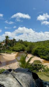 a view of a beach with people on the sand at Pousada Cordel de Itaúnas in Itaúnas