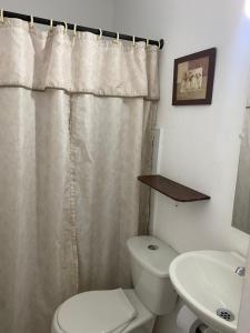 a bathroom with a white toilet and a sink at La Casa de Luzma in Pueblo Bello +30 photos