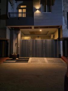 a fence in front of a building at night at Yogqala Homestay 04 in Jaipur