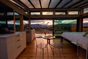 a bedroom with a bed and a table and chairs at Haurapa PurePod in Cromwell
