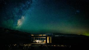 a house under a starry night with the milky way at Haurapa PurePod in Cromwell +7 photos