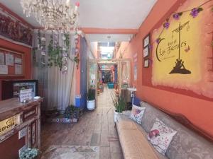 a living room with a couch and a hallway at Hotel Los Faroles, Villa del Carbón in Villa del Carbón