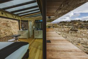 a bedroom with a bed and a wooden floor at Tāima PurePod in Cromwell