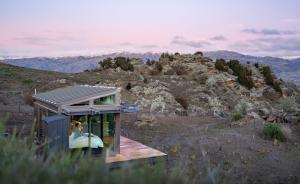 a small house on the side of a mountain at Tāima PurePod in Cromwell