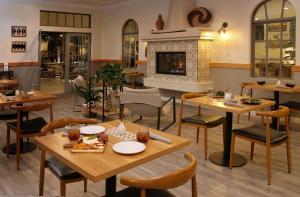 a restaurant with tables and chairs and a fireplace at Azure Palm Hot Springs in Desert Hot Springs