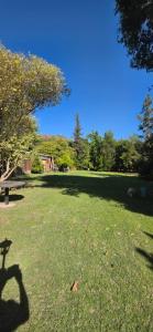 a shadow of a person on the grass in a park at Bed&Breakfast in Maipo
