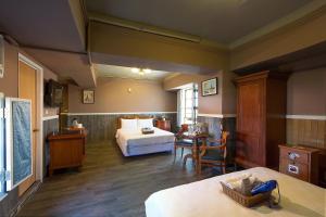 a bedroom with a bed and a table in a room at 翠安儂風旅 in Taitung City +171 photos