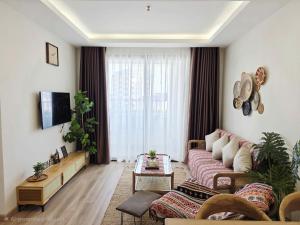 a living room with a couch and a table at Smile House - With In-unit Laundry & Kitchen in Sapa
