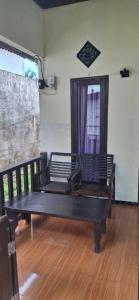 two benches sitting on a wooden floor in a room at SOLLA_Homestay in Gili Islands