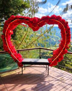 a heart made out of flowers on a deck at Omghat Glamping - Domo Ganesha in El Peñol +2 photos
