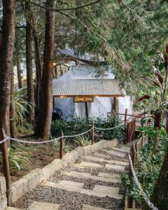 a set of stairs leading up to a white building at Omghat Glamping - Domo Ganesha in El Peñol