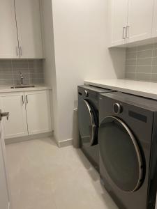 a kitchen with a washing machine and a sink at B-Willowdale Cummer Residence -Queen bedroom near Yonge-Finch in Toronto