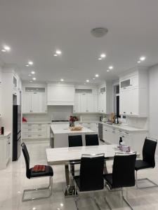 a large white kitchen with a table and chairs at B-Willowdale Cummer Residence -Queen bedroom near Yonge-Finch in Toronto