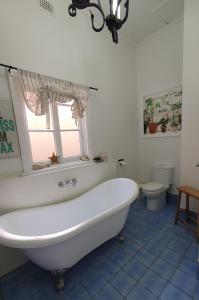 a white bath tub in a bathroom with a toilet at Haven Cottage Kangaroo Island in Kingscote +48 photos