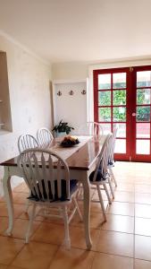 a dining room with a wooden table and chairs at Haven Cottage Kangaroo Island in Kingscote