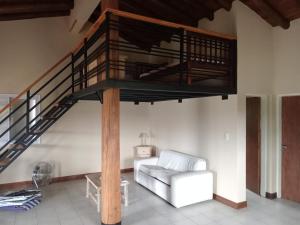 a living room with a loft bed and a couch at Posada del Río 2 in Ciudad Lujan de Cuyo