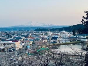 a view of a city with a mountain in the background at SUBAKO - Vacation STAY 90330v in Yurihonjo