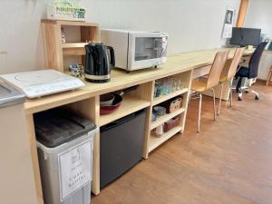 a desk with a microwave and a computer on it at SUBAKO - Vacation STAY 90330v in Yurihonjo