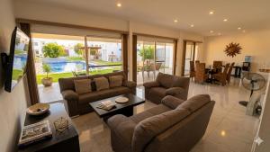 a living room with two couches and a table at Home in Tequesquitengo in Tequesquitengo
