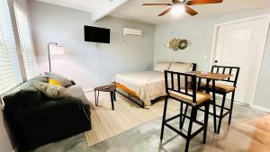 a living room with a bed and a table and a couch at The Perfect One Night Stay in Jacksonville