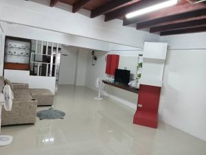 a living room with a couch and a tv at Anchan Home Stay Hatyai in Hat Yai