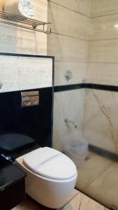 a bathroom with a toilet and a shower at Mayuri Residency BTM Layout in Bangalore