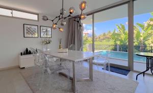 a dining room with a white table and chairs at Maerim Luxury 3BR Pool Villa with Mountain View in Ban Tai
