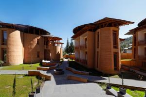 a group of buildings with a courtyard with benches at Amba Paro in Paro +4 photos