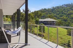 a hammock on the deck of a house with a view at Eildon Valley Views in Eildon
