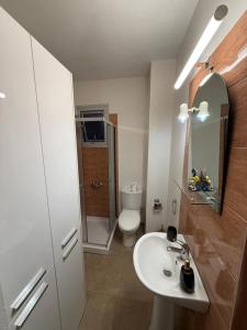 a bathroom with a sink and a toilet and a mirror at 777 Stars in Paphos +34 photos