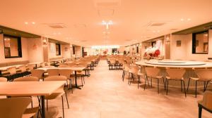 a dining hall with tables and chairs in a building at Rita Hotel Namba in Osaka