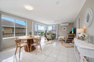 a living room with a table and chairs at Seychelle unit 5 Kings Beach in Caloundra