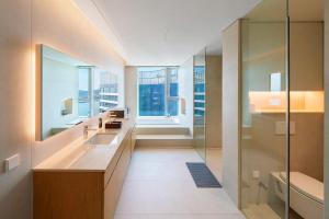 a bathroom with a sink and a glass shower at Busan Station BOOKING THE BAY in Busan +191 photos