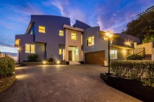 a house with a driveway in front of it at Ocean View Self-contained Apartment in Porirua