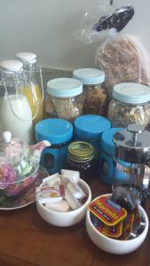 a counter top with jars of food and a bunch of ingredients at Ocean View Self-contained Apartment in Porirua