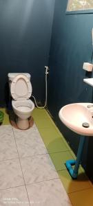 a bathroom with a toilet and a sink at 3 Star and the Sun in Ban Nua