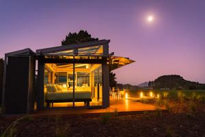 a glass house with a view of the moon at Matū PurePod - Waitomo in Otorohanga +4 photos