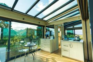 a conservatory with a kitchen with a glass ceiling at Matū PurePod - Waitomo in Otorohanga