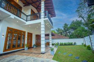 an exterior view of a house with a yard at Palms shede Villa in Habaraduwa Central