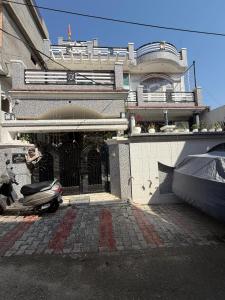 a building with a scooter parked in front of it at Home stays in Jammu